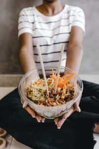 A photo of a creator holding out a rice bowl