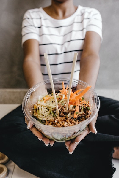 A photo of a creator holding out a rice bowl
