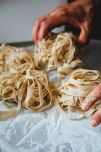A creator making fresh pasta from scratch
